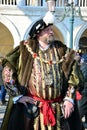 An unidentified man stands in Piazza San Marco dressed in a regal fancy dress during Venice Carnival